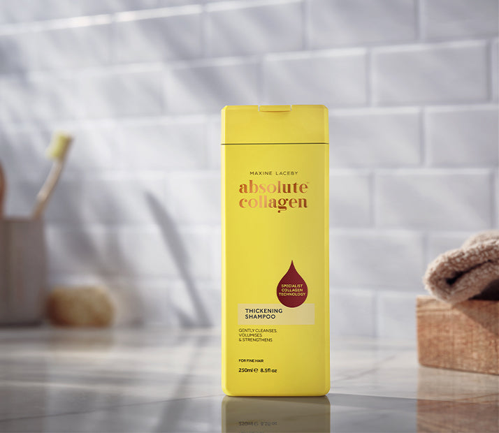 Image of a bottle of Absolute Collagen Thickening Shampoo in a bathroom